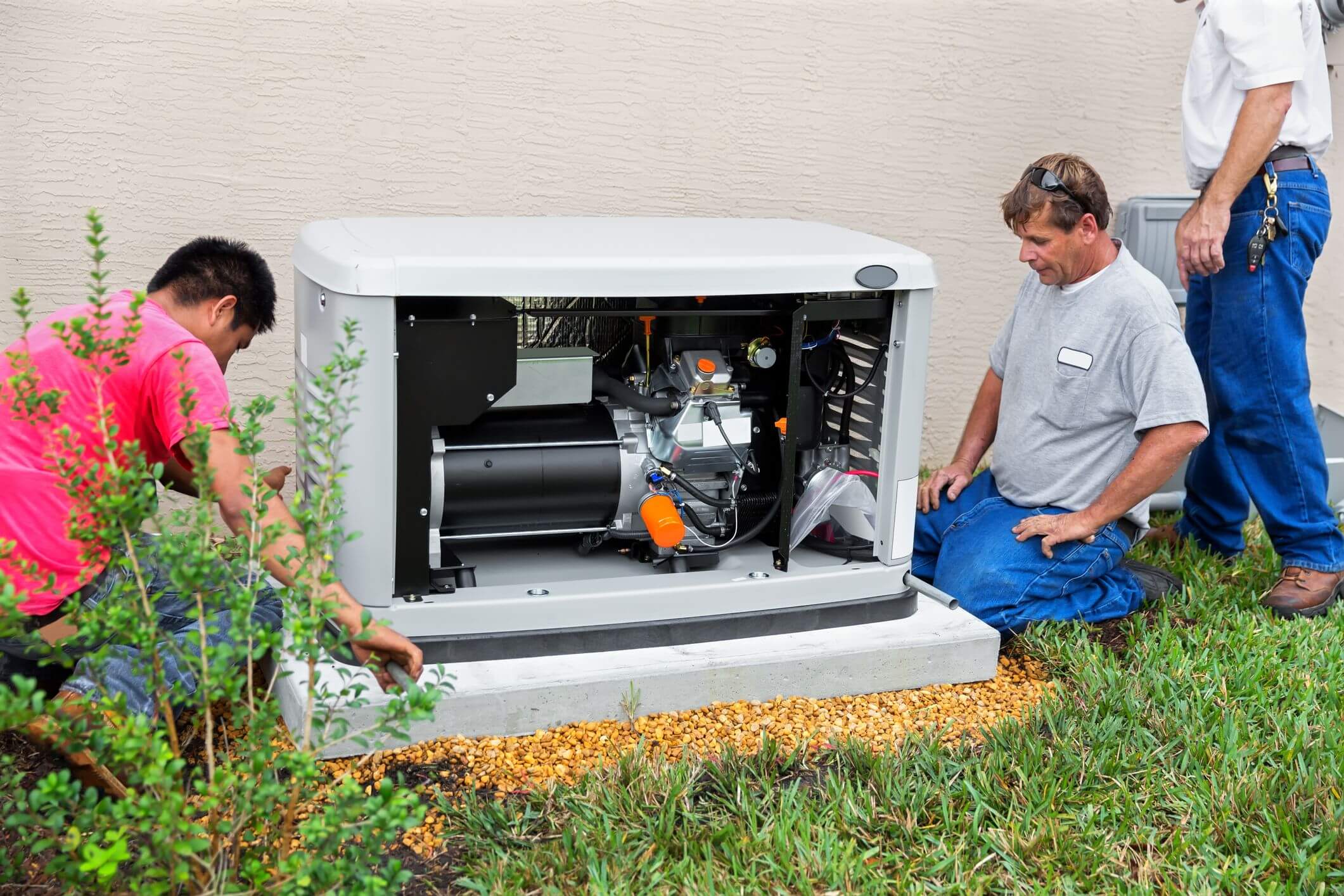 Three Laswell Electric electricians installing a home backup generator, ensuring reliable power solutions for homeowners in Kentucky and Indiana during outages or emergencies.