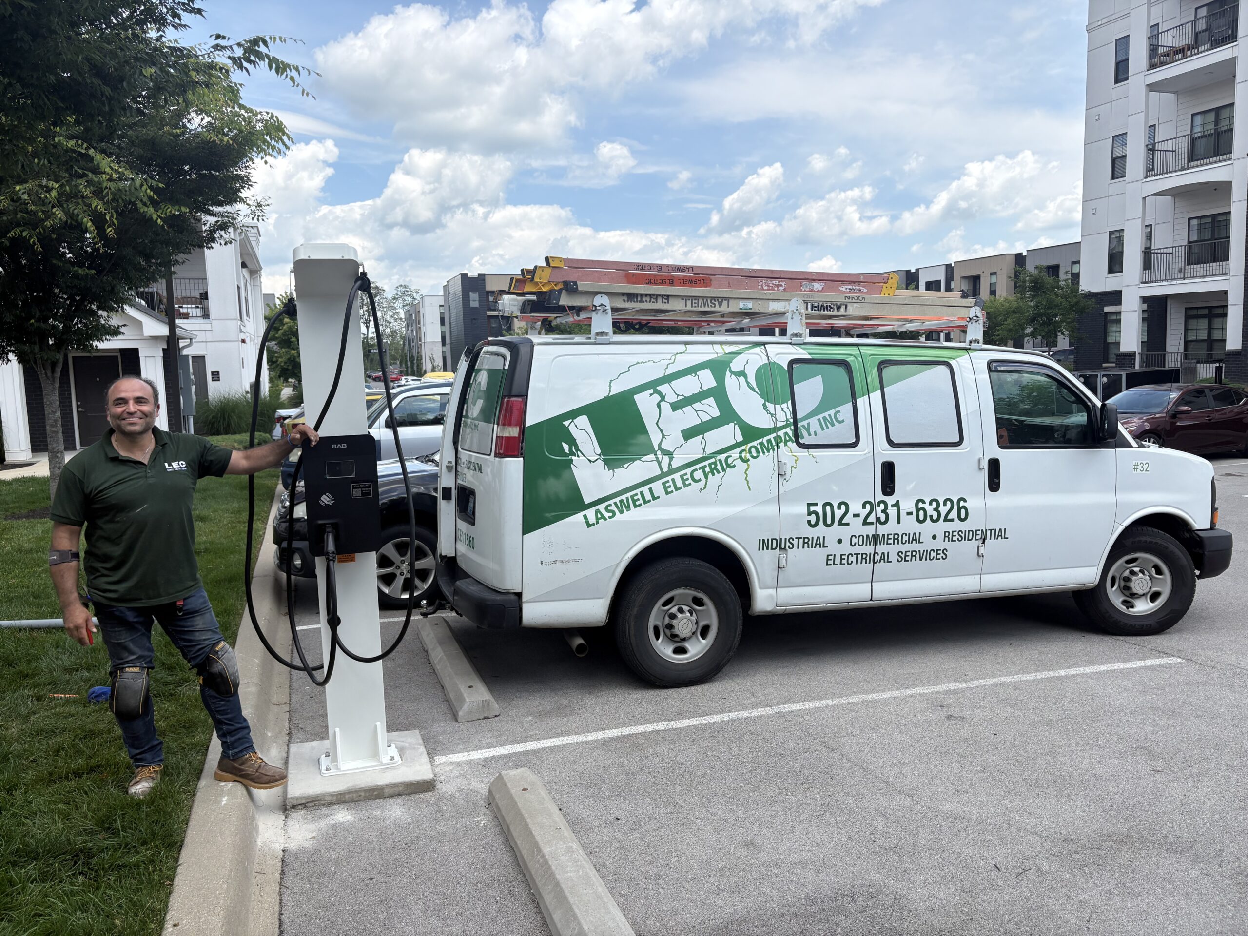 Laswell Electric technician standing next to a newly installed EV charger.