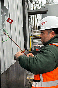 Licensed commercial electrician performing electrical work outside a business in Middletown, KY, servicing commercial wiring, panels, and electrical systems.